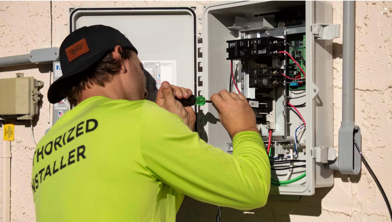 Electrician working on an electrical panel